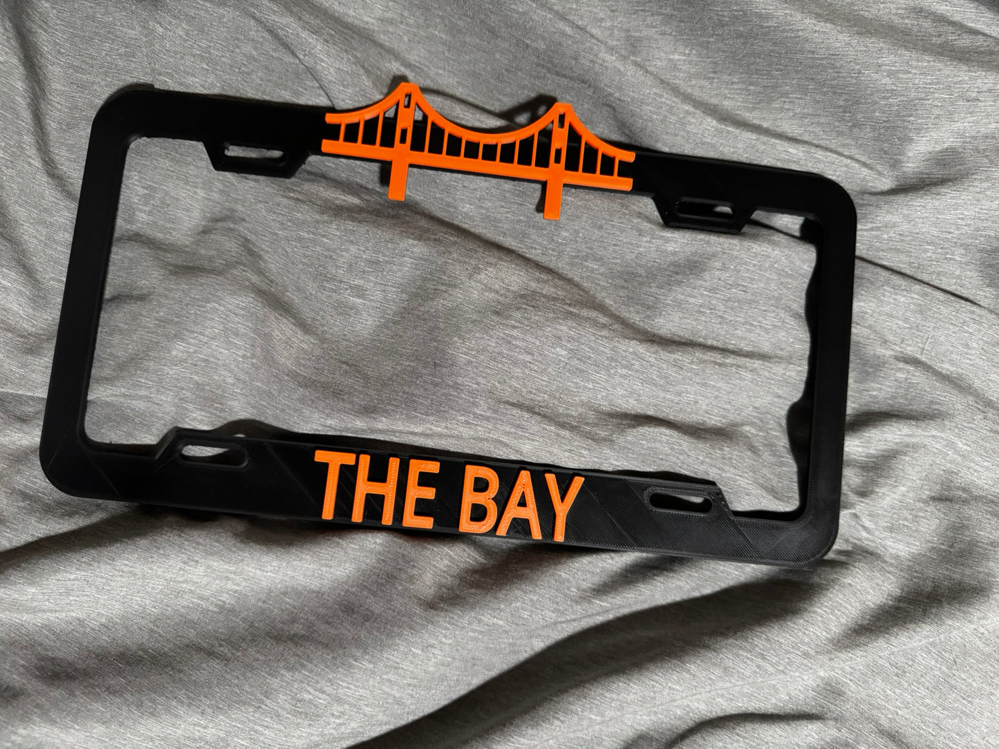 THE BAY License Plate Cover Black/Orange