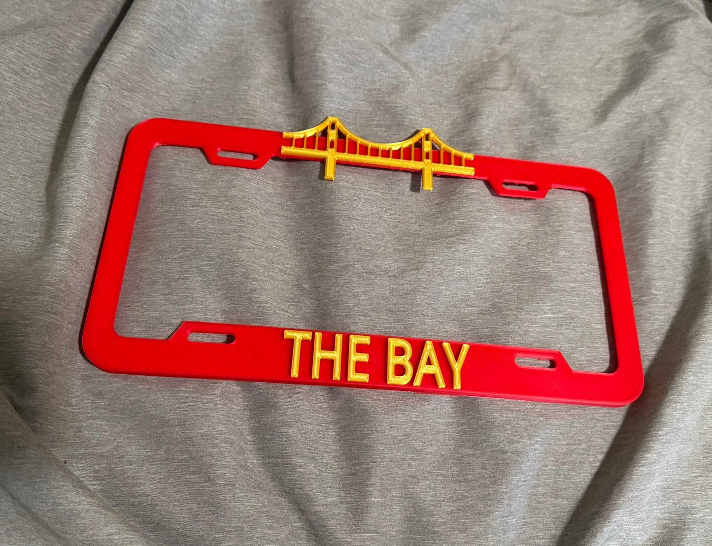 THE BAY License Plate Cover Red/Silk Gold